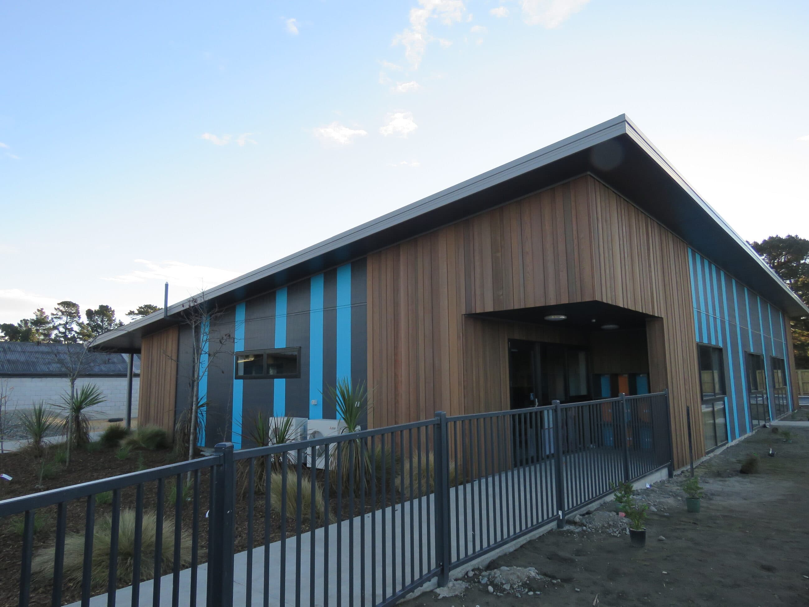 The covered entry, with the fenced approach and new planting alongside.